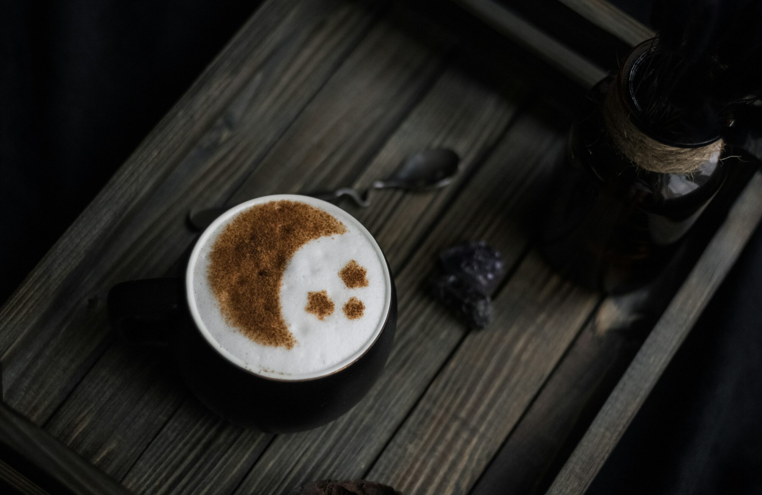 A foamy beverage with moon & stars decorations in chocolate powder